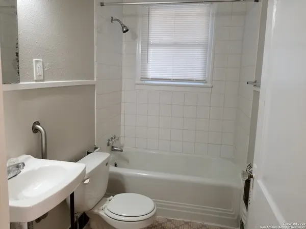 a bathroom with a toilet sink and bathtub