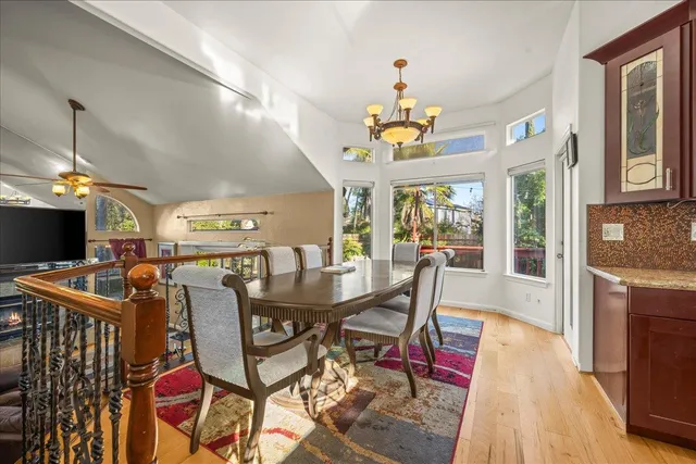 a view of a dining room with furniture and a chandelier