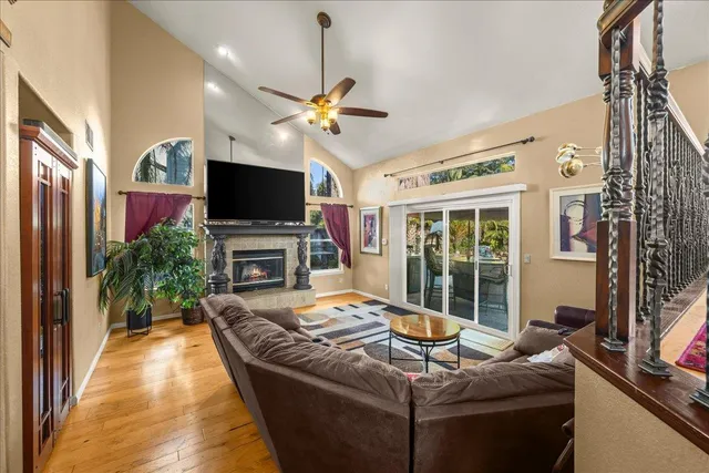 a living room with furniture a fireplace and a flat screen tv