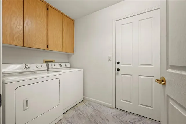 a view white kitchen island a sink a counter top space and a window