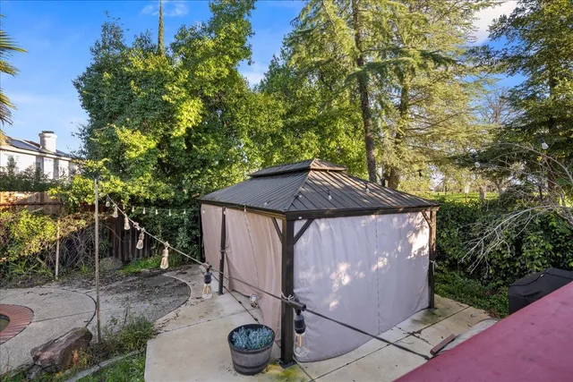 a view of a chairs and table in the patio in front of a house