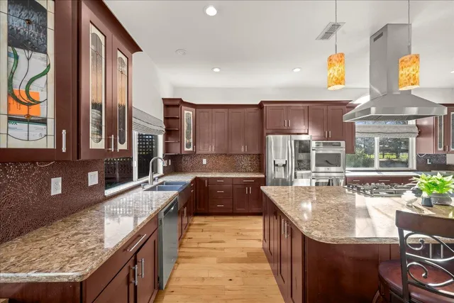 a large kitchen with granite countertop a sink and a stove