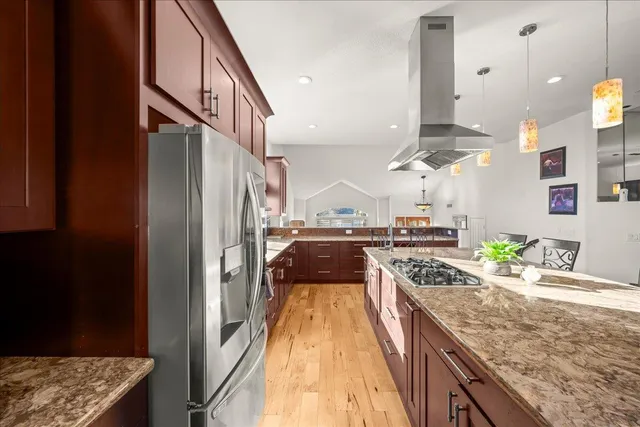 a kitchen with stainless steel appliances granite countertop a stove and a sink
