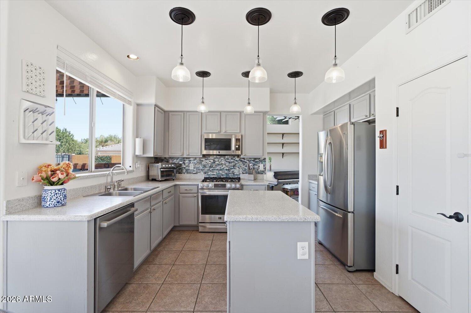 1894 East Mineral Road Gilbert, AZ 85234 - Photo 8 of 48 a kitchen with a sink stainless steel appliances and cabinets