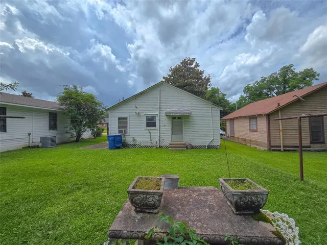 a backyard of a house with table and chairs