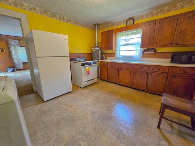 a kitchen with stainless steel appliances a refrigerator sink and cabinets