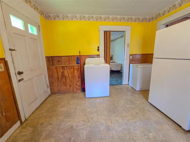 a view of a kitchen from a hallway