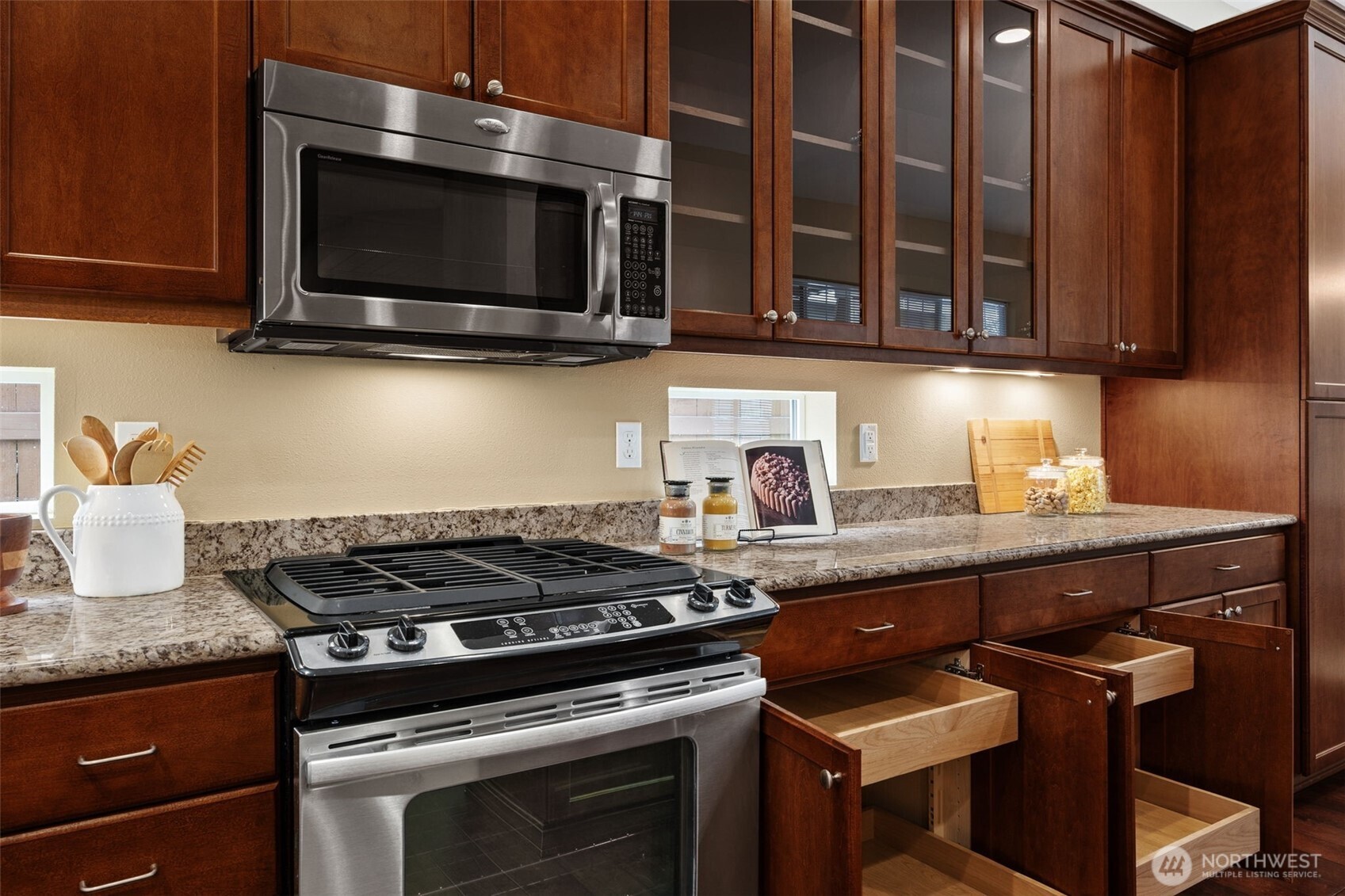 8265 Orcas Loop Northeast Lacey, WA 98516 - Photo 11 of 40 a kitchen with stainless steel appliances granite countertop a stove and a microwave