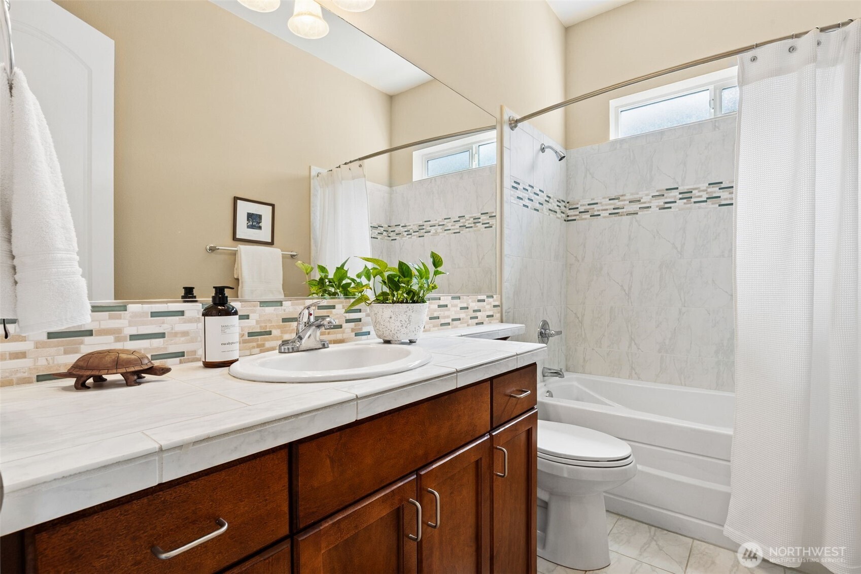 8265 Orcas Loop Northeast Lacey, WA 98516 - Photo 17 of 40 a bathroom with a granite countertop sink a toilet and shower