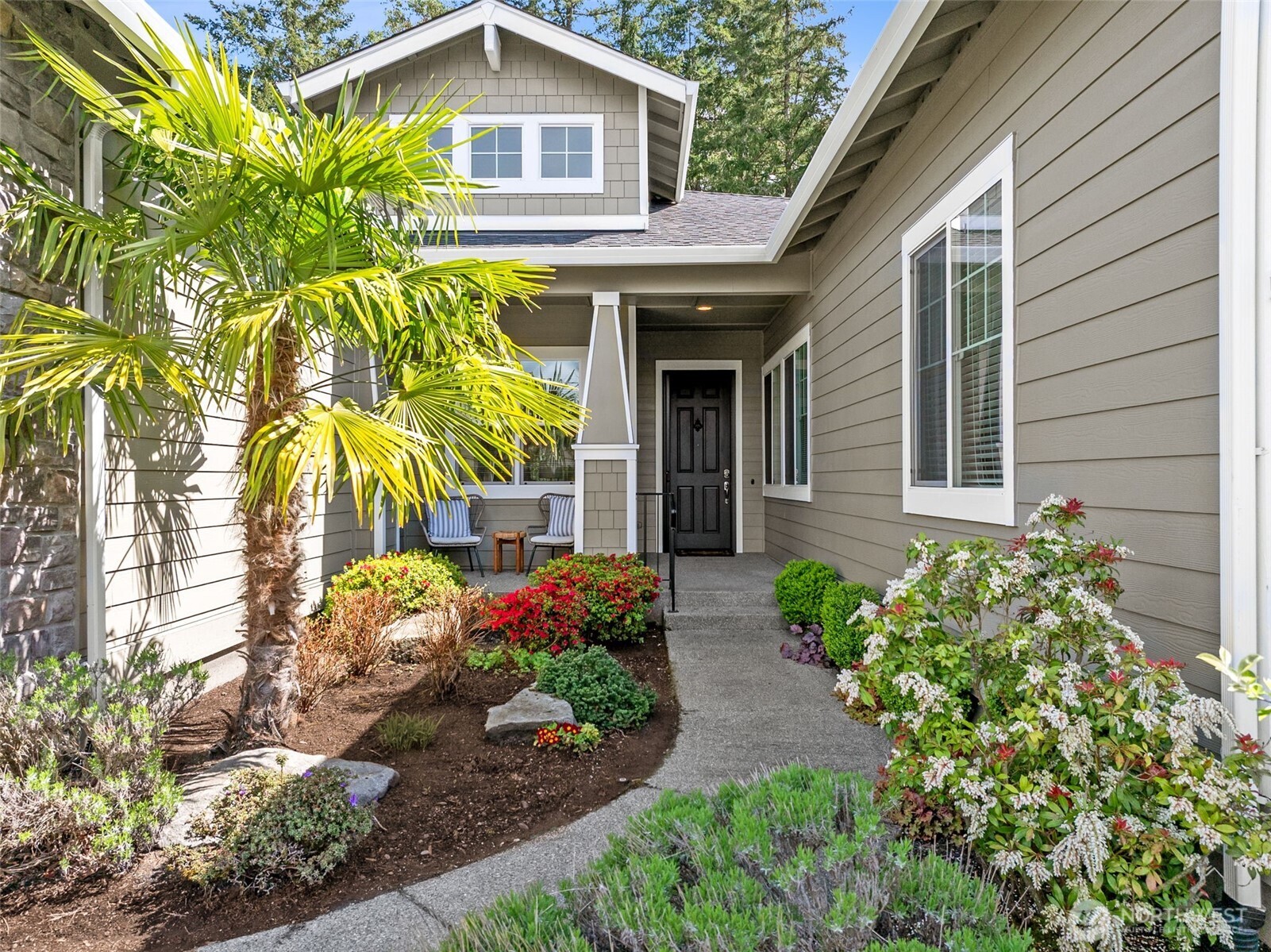8265 Orcas Loop Northeast Lacey, WA 98516 - Photo 2 of 40 a front view of a house with a garden
