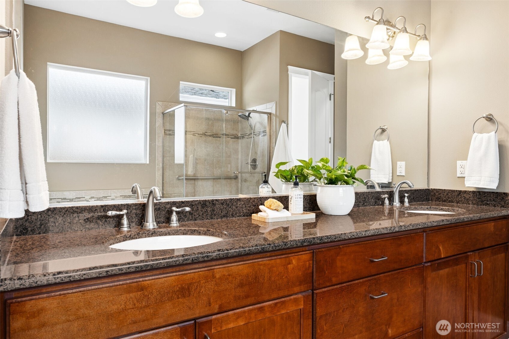 8265 Orcas Loop Northeast Lacey, WA 98516 - Photo 23 of 40 a bathroom with a granite countertop sink and a mirror