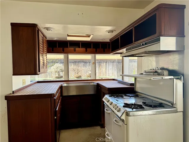 a kitchen with a stove and a refrigerator