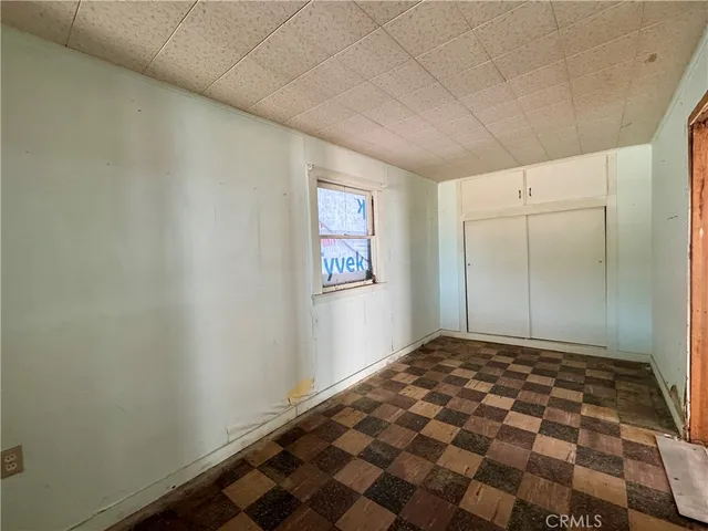 a room with a wooden floor and window