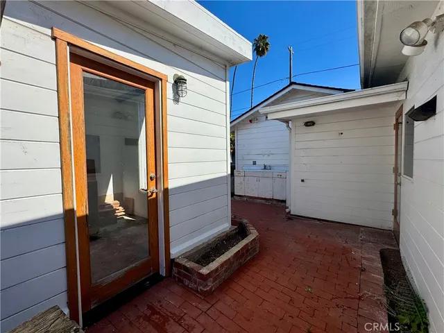 a backyard of a house with table and chairs