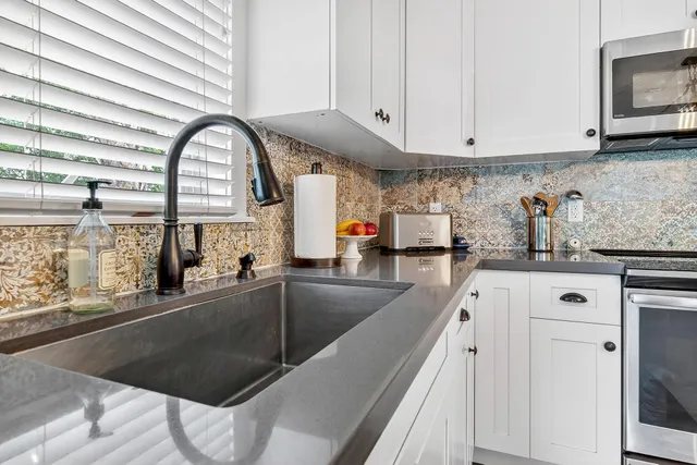 a bathroom with a toilet a sink and a window