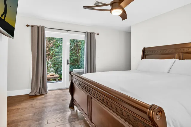 a view of a hallway with wooden floor and entryway