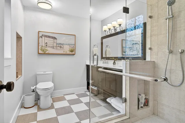 a kitchen with stainless steel appliances granite countertop a refrigerator a microwave a stove and a dining table with wooden floor