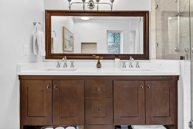 a kitchen with stainless steel appliances granite countertop a refrigerator a stove a sink a microwave and dining table with wooden floor