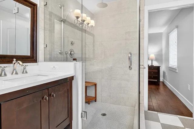 a bathroom with a sink vanity and a mirror