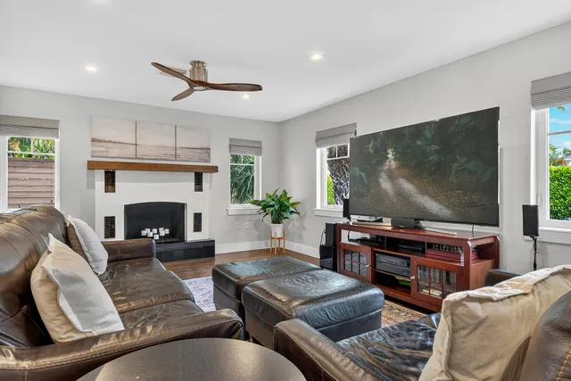 a living room with furniture a fireplace and a chandelier