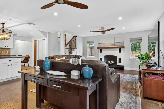 a kitchen with stainless steel appliances granite countertop a refrigerator a stove a sink dishwasher and a refrigerator with wooden floor