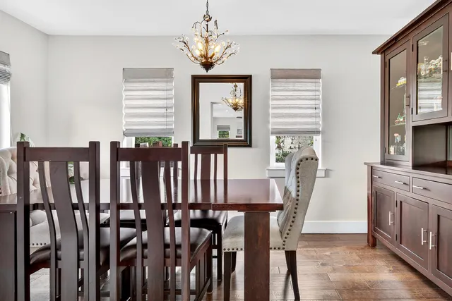 a kitchen with granite countertop white cabinets and stainless steel appliances