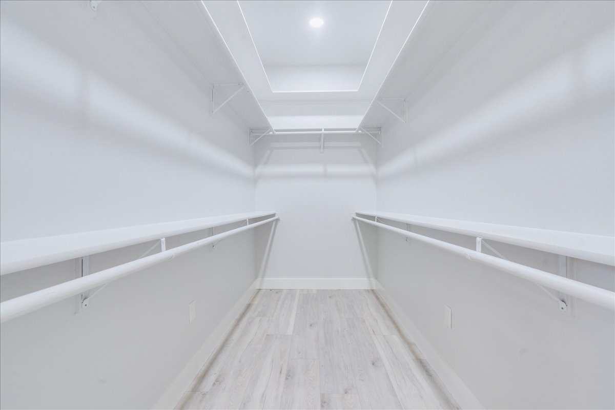 1215 Howard Street Taylor, TX 76574 - Photo 15 of 37 Spacious closet featuring wood finished floors with plenty of shelving for storage