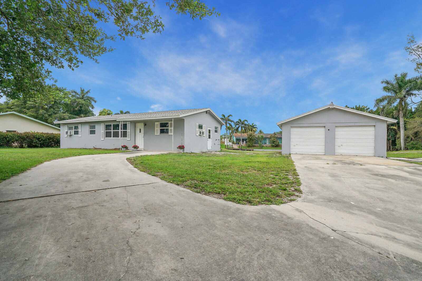 3230 Buccaneer Road Lake Worth, FL 33462 - Photo 1 of 24 a view of house with yard and green space