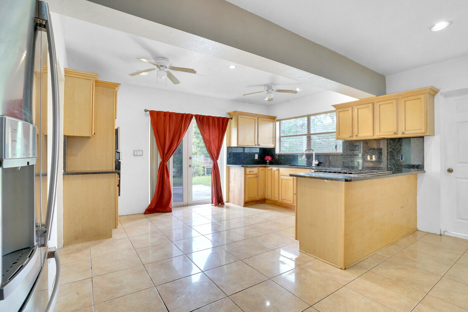 3230 Buccaneer Road Lake Worth, FL 33462 - Photo 12 of 24 a kitchen with stainless steel appliances granite countertop a refrigerator and a stove