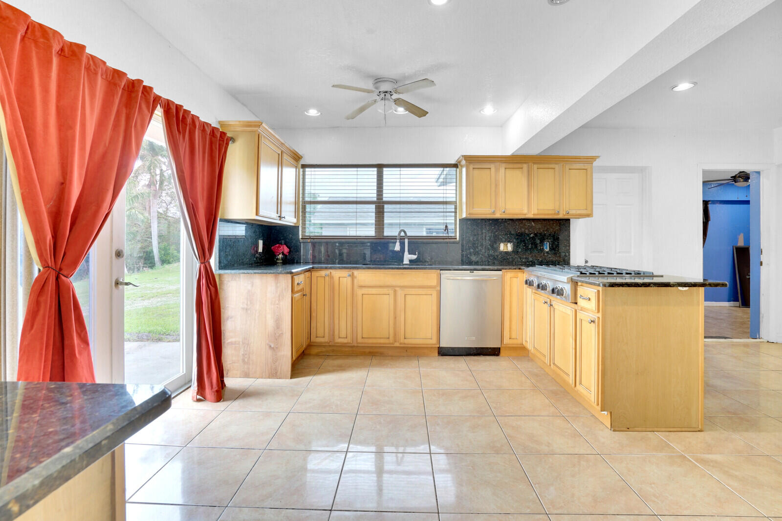 3230 Buccaneer Road Lake Worth, FL 33462 - Photo 13 of 24 a kitchen with stainless steel appliances granite countertop a refrigerator a sink and a stove