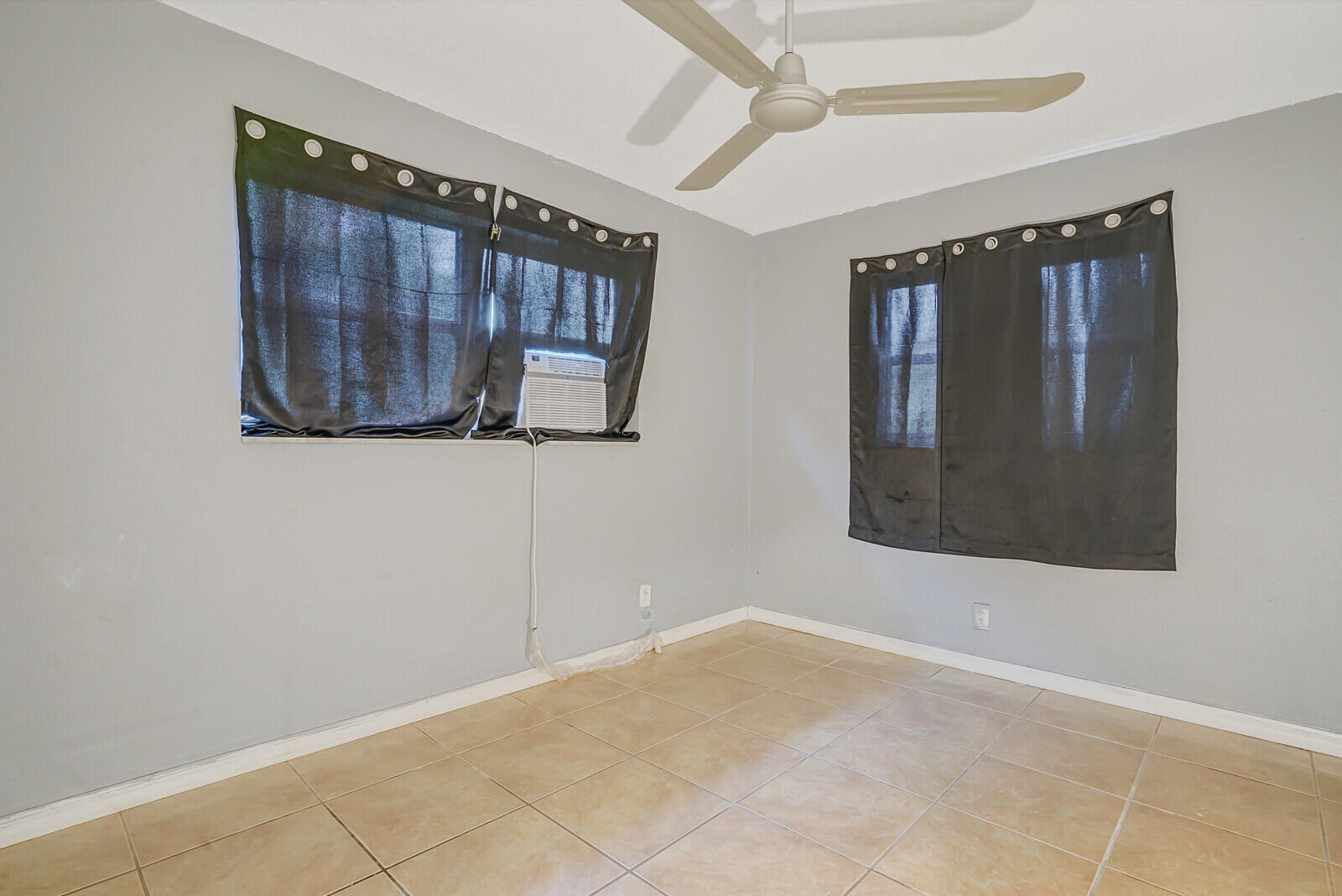 3230 Buccaneer Road Lake Worth, FL 33462 - Photo 20 of 24 a view of an empty room with wooden floor and a window