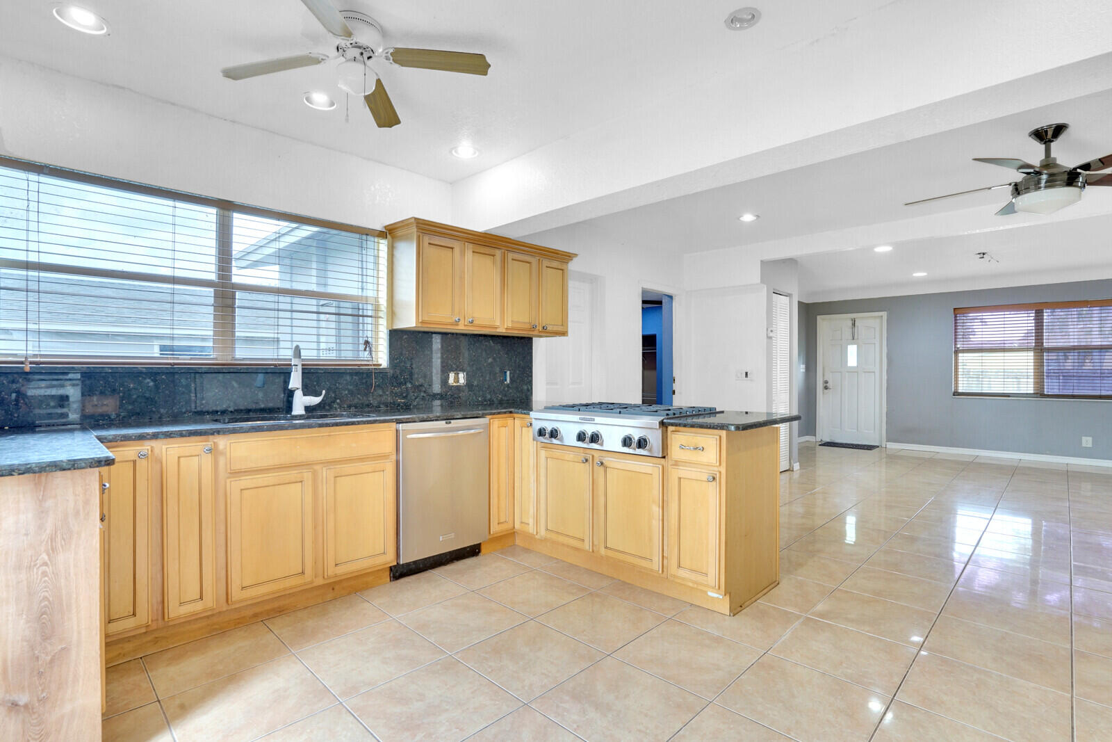 3230 Buccaneer Road Lake Worth, FL 33462 - Photo 3 of 24 a large kitchen with stainless steel appliances granite countertop a sink and a counter top space