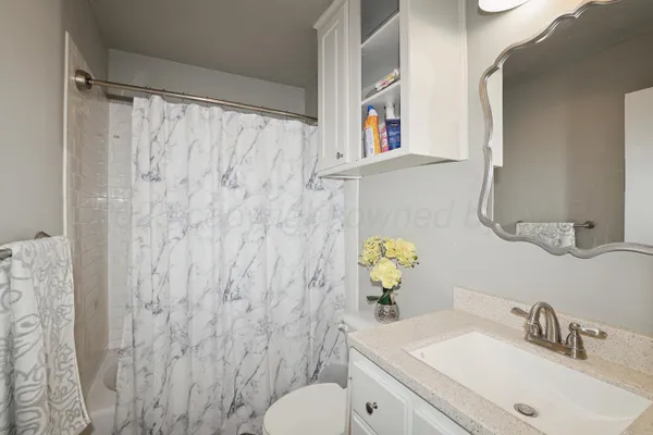 a bathroom with a sink mirror and vanity