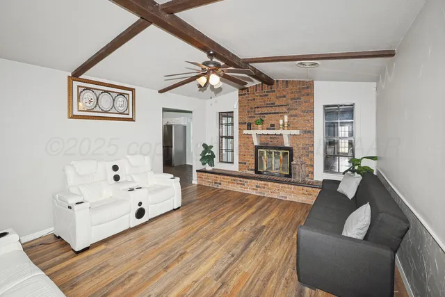 a living room with furniture and a fireplace