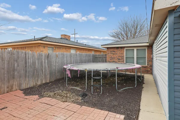 a backyard of a house with table and chairs