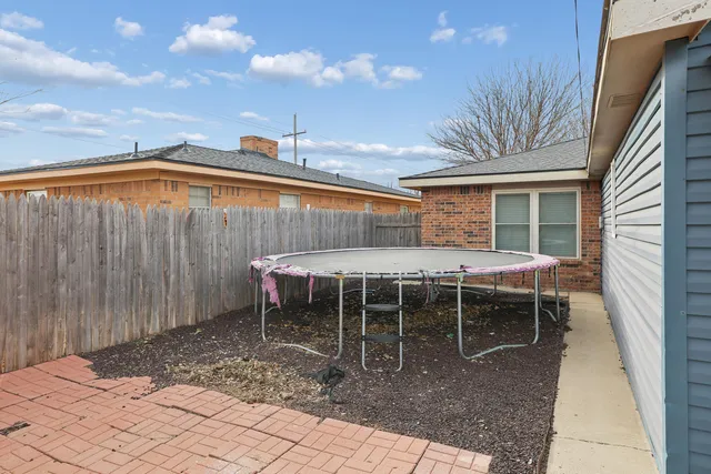 a backyard of a house with table and chairs