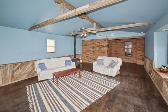 a bedroom with furniture and wooden floor