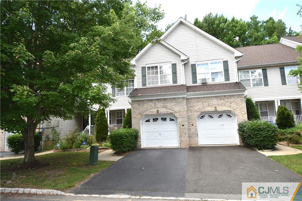 248 Hawthorne Road North Brunswick, NJ 08902 - Photo 1 of 24 a view of a white house with large windows and a small yard