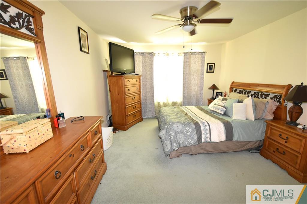 248 Hawthorne Road North Brunswick, NJ 08902 - Photo 11 of 24 a bedroom with a bed dresser and a flat tv screen
