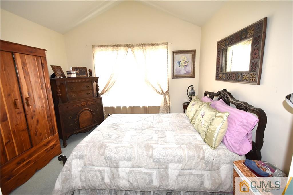 248 Hawthorne Road North Brunswick, NJ 08902 - Photo 13 of 24 a bedroom with a bed and wooden floor