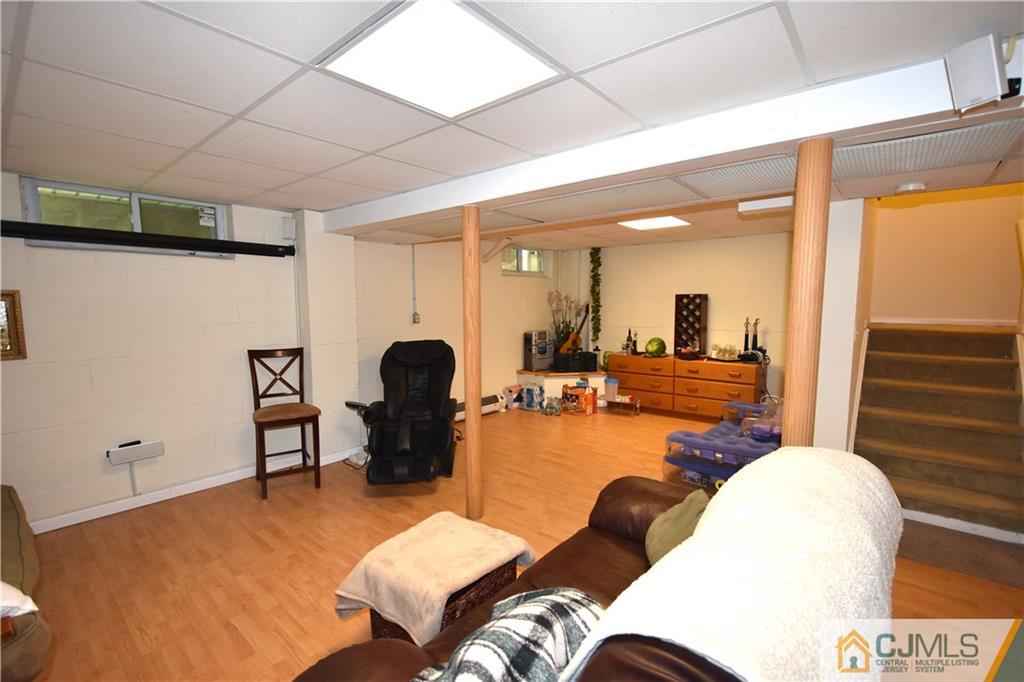 248 Hawthorne Road North Brunswick, NJ 08902 - Photo 17 of 24 a living room with furniture a wooden floor and a large window