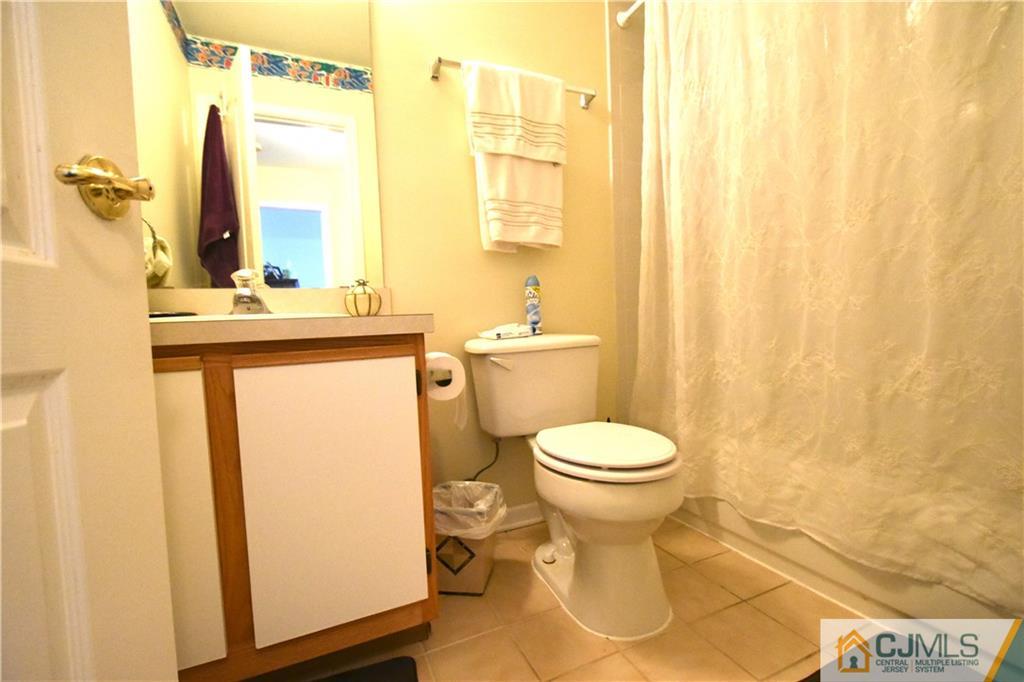 248 Hawthorne Road North Brunswick, NJ 08902 - Photo 22 of 24 a bathroom with a toilet sink and a mirror