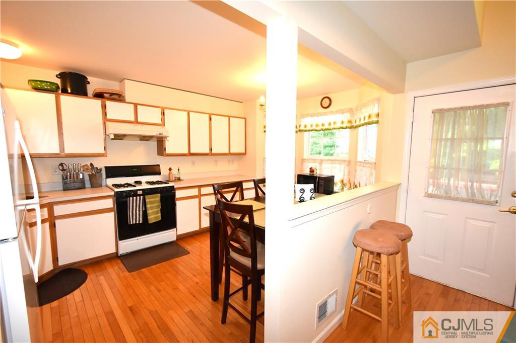 248 Hawthorne Road North Brunswick, NJ 08902 - Photo 9 of 24 a kitchen with granite countertop a stove a sink and a refrigerator