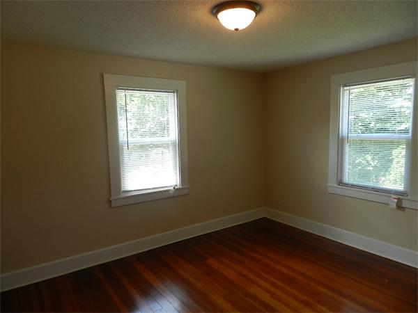 196 Pasco Road Springfield, MA 01151 - Photo 12 of 19 an empty room with wooden floor and windows