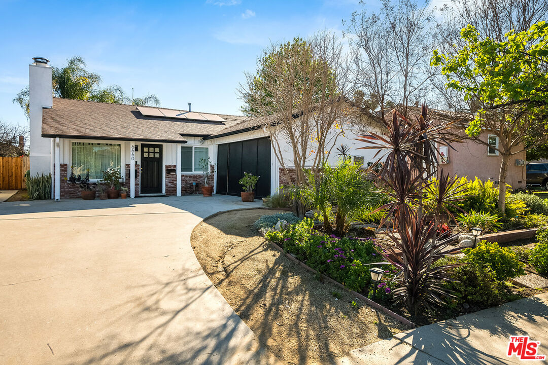 a view of house with yard and entertaining space