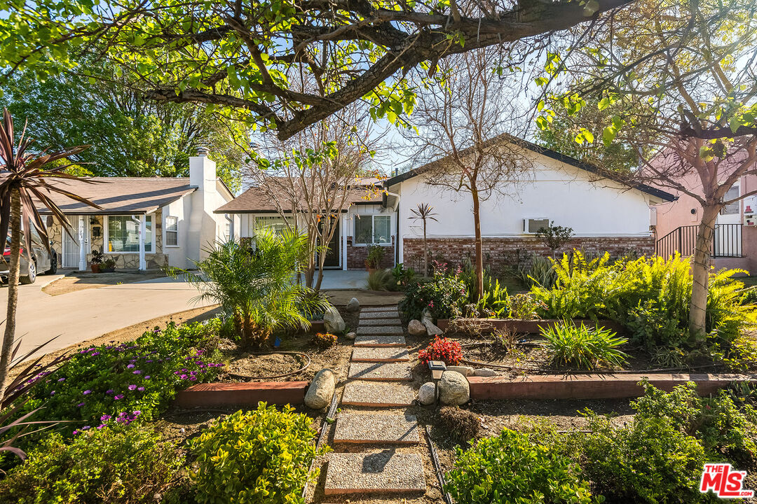 6660 Amigo Avenue Reseda, CA 91335 - Photo 3 of 25 a front view of a house with a yard and outdoor seating