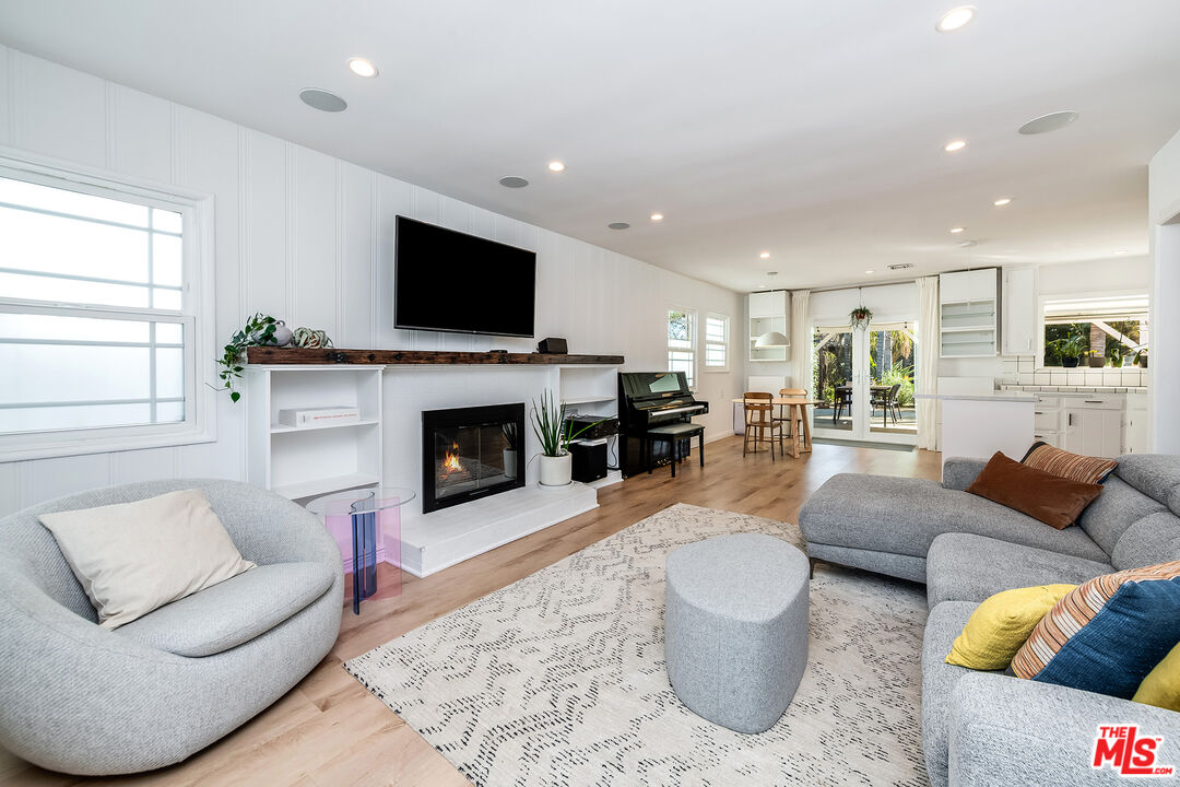 6660 Amigo Avenue Reseda, CA 91335 - Photo 5 of 25 a living room with furniture a flat screen tv and a fireplace