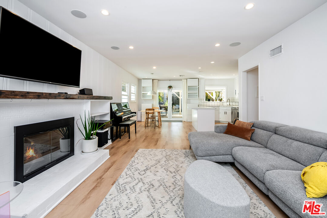 6660 Amigo Avenue Reseda, CA 91335 - Photo 6 of 25 a living room with furniture a flat screen tv and a fireplace