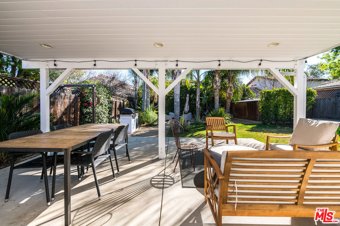 6660 Amigo Avenue Reseda, CA 91335 - Photo 9 of 25 a view of a patio with a dining table and chairs with wooden floor