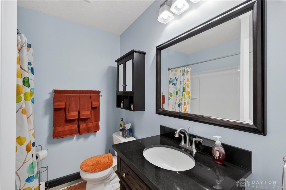 2165 Stewart Road Xenia, OH 45385 - Photo 38 of 59 This clean bathroom provides a functional vanity with a sleek sink and a classic shower.